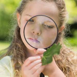 picture of girl using a magnifying lens